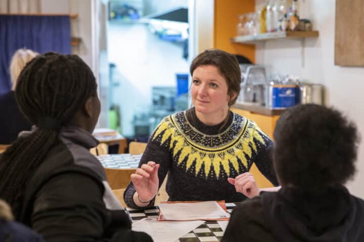 Woman talks to two young people in Hackney Wick