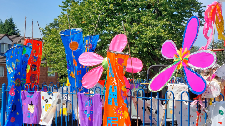 Brightly coloured flowers and flags on display outside