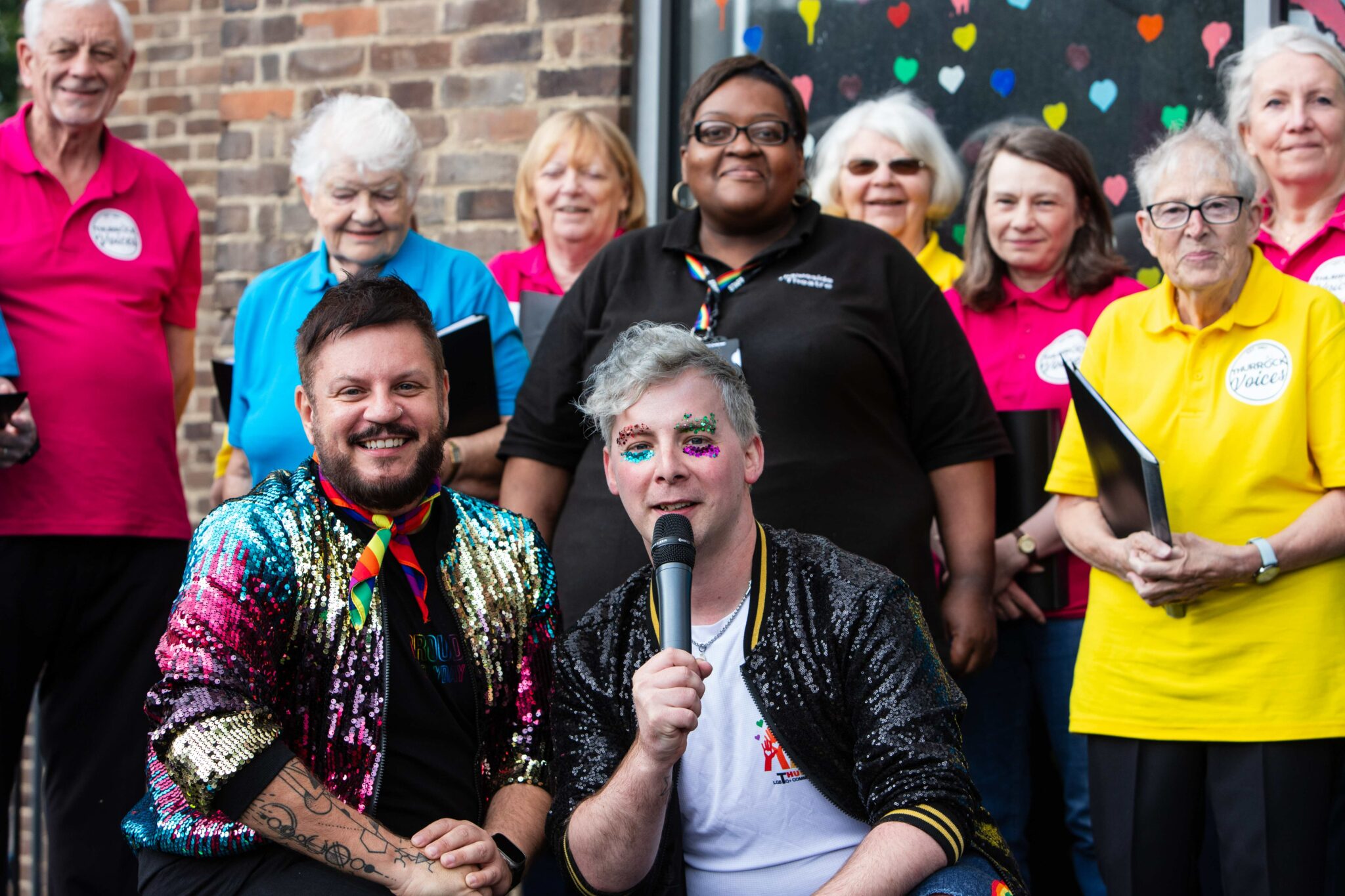 Young people in costumes laughing and talking, with one of them holding a sign that says 'Team goblin'