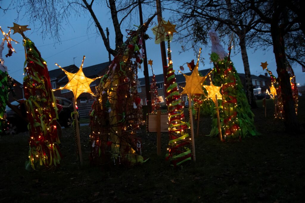Christmas stars and decorations hang from trees