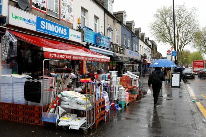A busy street with a shop selling homewares nearby.
