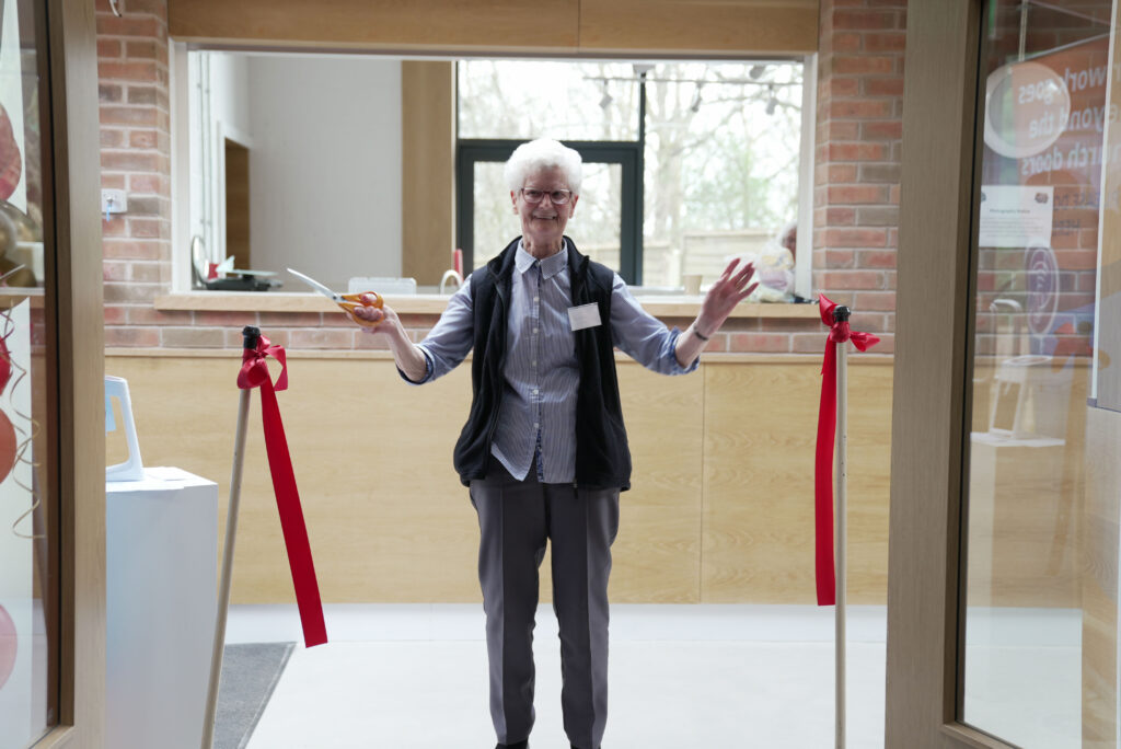 Dorothy McAllister cutting the ribbon to open Windmill Hill community centre