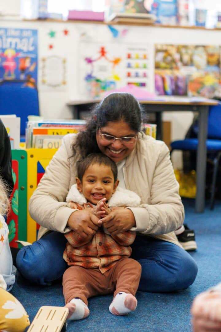 Mother and baby clapping in a library