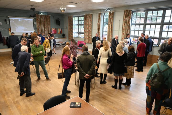 A crowd of people in a community hub, a key example of social infrastructure