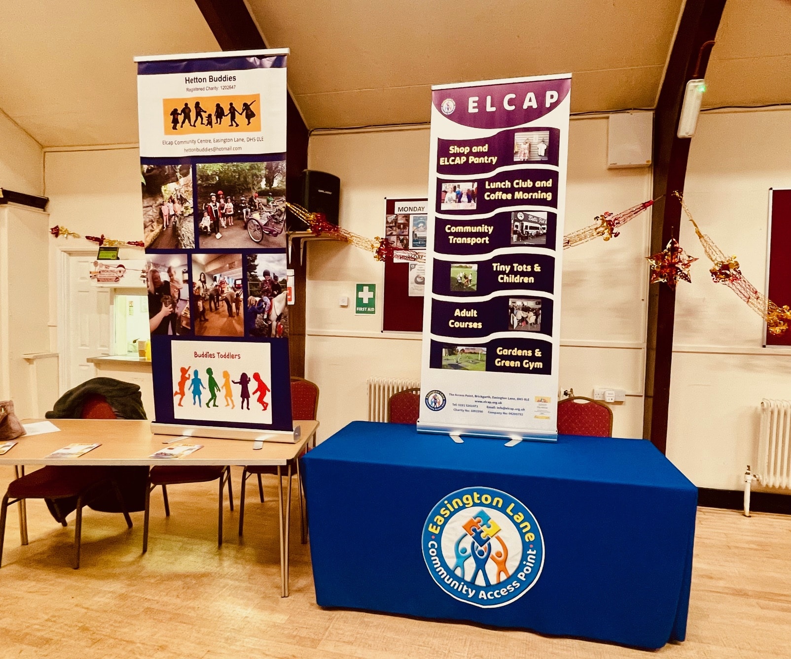 Banners of Hetton Buddies and ELCAP displayed in the community hub