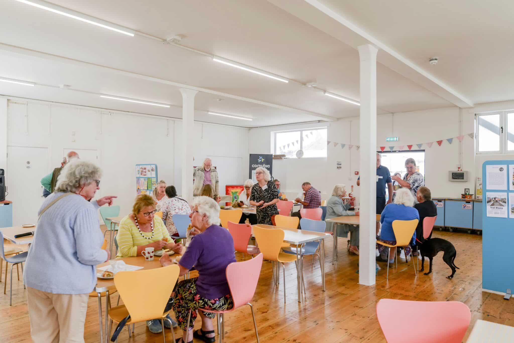 People sitting at tables in Cornubia community hub.