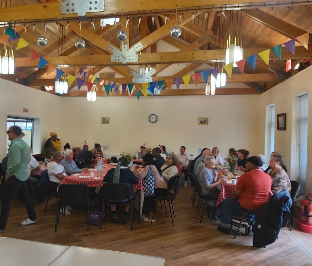 People eating together at Christmas at Wick Award Big Local. 